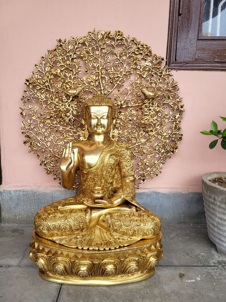 brass buddha with tree